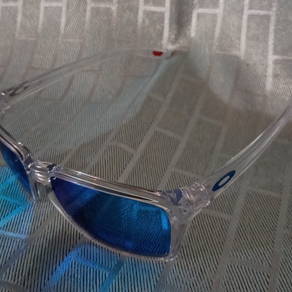 Oakley Transparent Frame Sunglasses with Deep Blue Lenses
